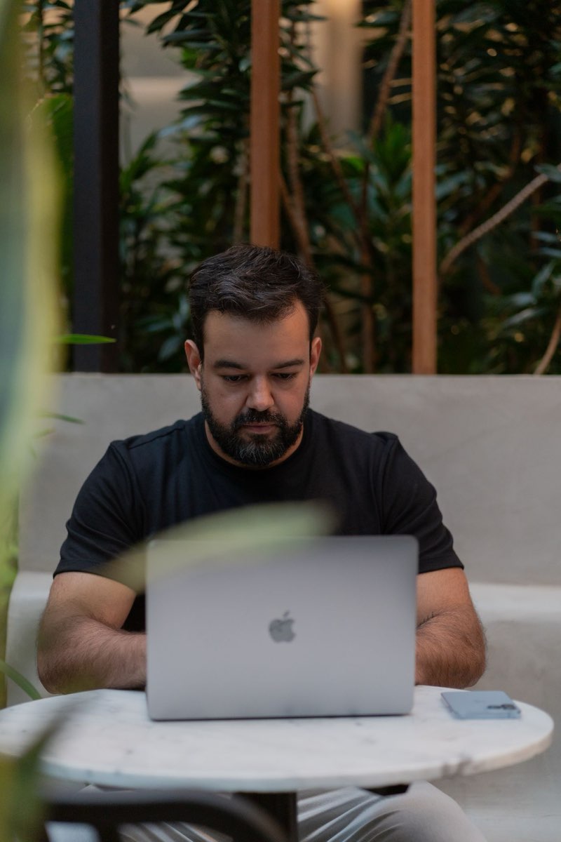 A marketer working on a laptop in a modern cafe